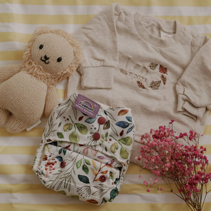 Baby clothing and toy on a striped yellow and white background